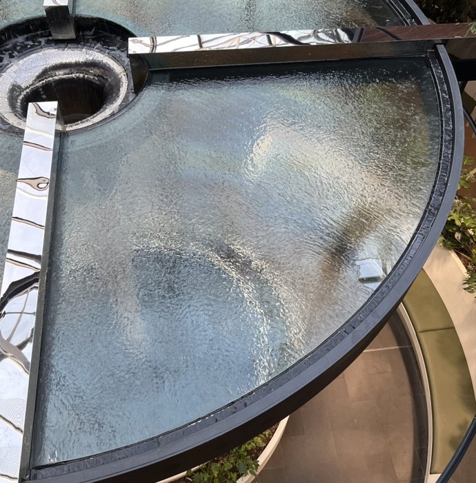 Custom glass spillway and water feature by h2o designs Close up of the handmade LICOM76 & Stainless water fountain spillway at Highpoint shopping centre by H2O Designs, Melbourne